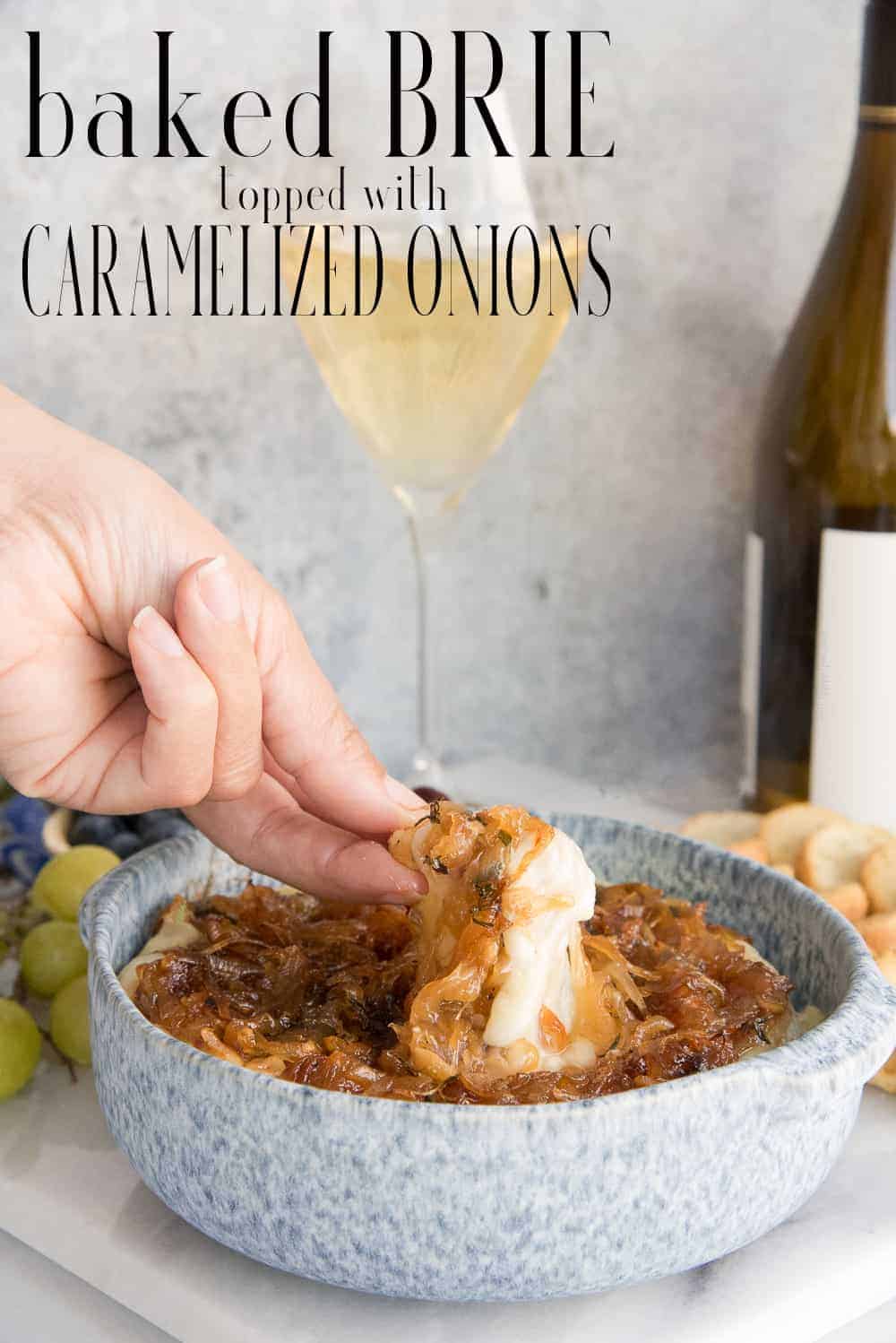 Baked Brie Topped with Caramelized Onions is an easy snack or party appetizer. Made with white wine, the caramelized onions can also be used to top your favorite burgers, pizzas, or poultry. #brie #cheese #meatandcheeseboard #cheeseboard #caramelizedonions #appetizer #starters #parties #cocktailparty #holiday #brierecipe #bakedbrie via @ediblesense