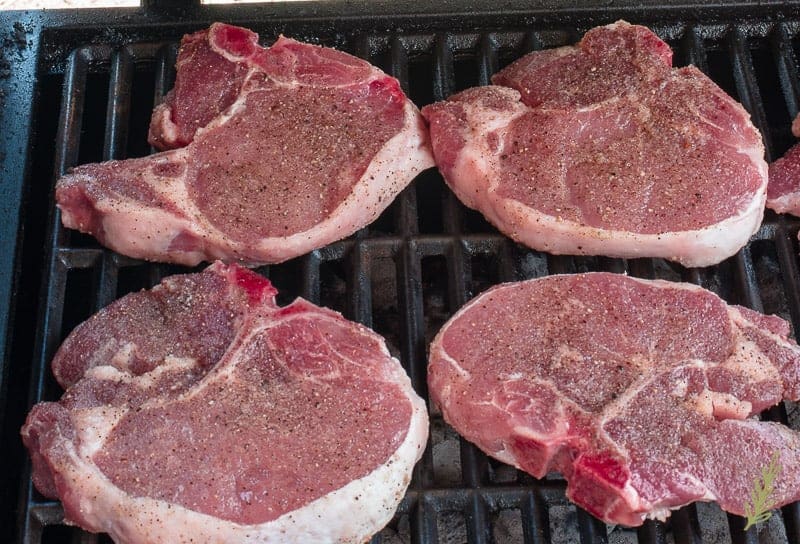 Pork chops are placed on the grill
