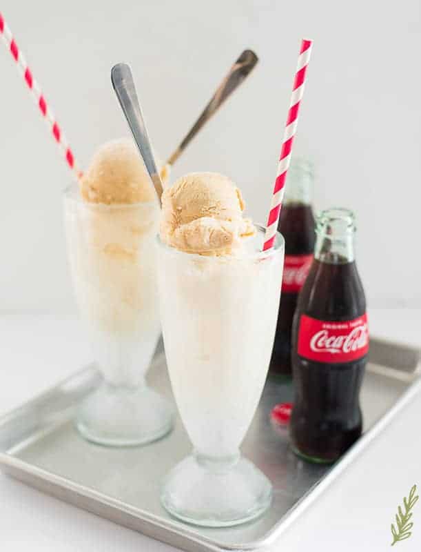 Horizontal image of two glasses filled with scoop of Vanilla Frozen Custard topped with coke soda