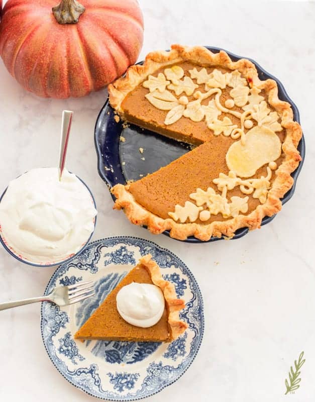a slice of Perfectly Easy Pumpkin Pie alongside the remaining pie