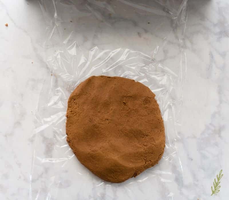 The gingerbread dough is formed into a disc before being wrapped in plastic and chilled.