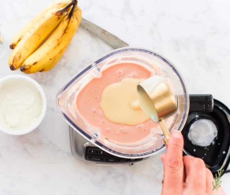 Condensed milk is added to the blender to sweeten the Guava Banana Oatmeal Breakfast Shake
