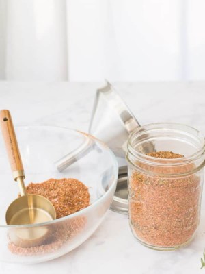 A jar of Meat Spice Blend next to a bowl filled with the remainder
