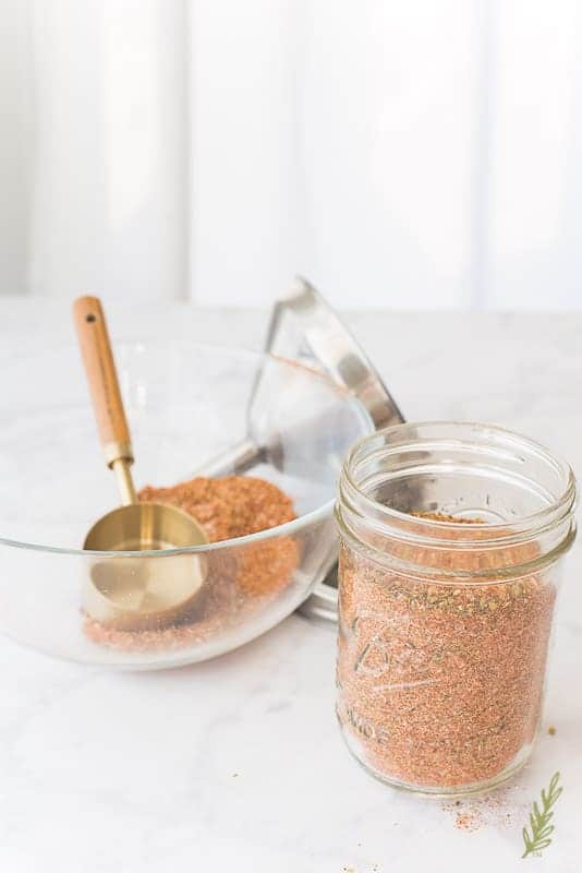 A glass mason jar filled with meat spice blend