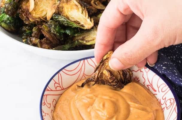 Dipping brussels sprouts into Gochujang Mayo