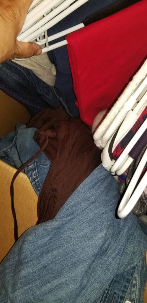 Clothing thrown into moving boxes.