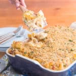 Lifting spoon of the Ultimate Bacon-Jalapeño Mac and Cheese from casserole dish