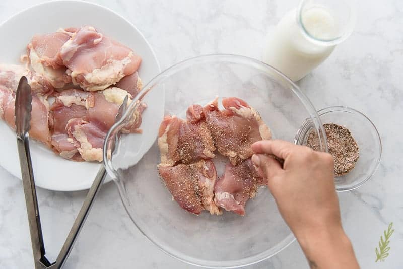 Seasoning the boneless, skinless chicken pieces