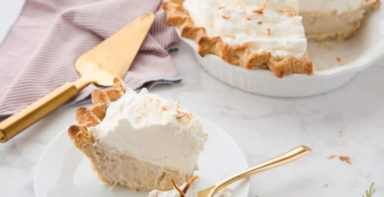 Side angle shot of a slice of Coconut Rum Cream Pie