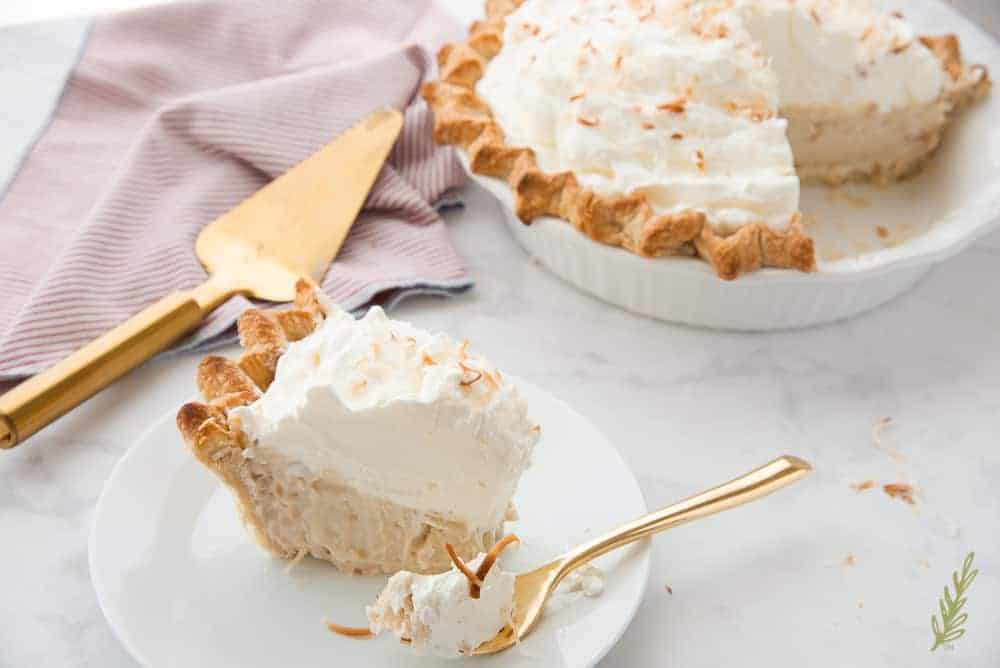 Side angle shot of a slice of Coconut Rum Cream Pie