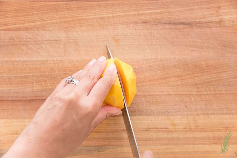 Overhead shot of cutting the fleshy part of a mango