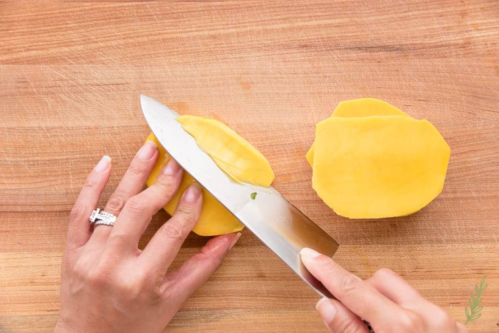 Cutting the side part of a mango