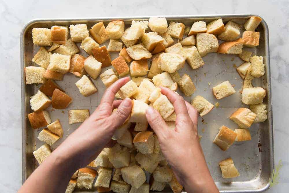 Tossing the bread cubes during baking