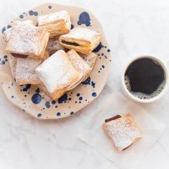 FB Image overhead shot of pastelillo de guayaba, a plate of pastelillos de guayaba and a mug of coffee