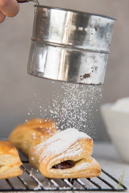 Sift the powdered sugar liberally over the pastelillos