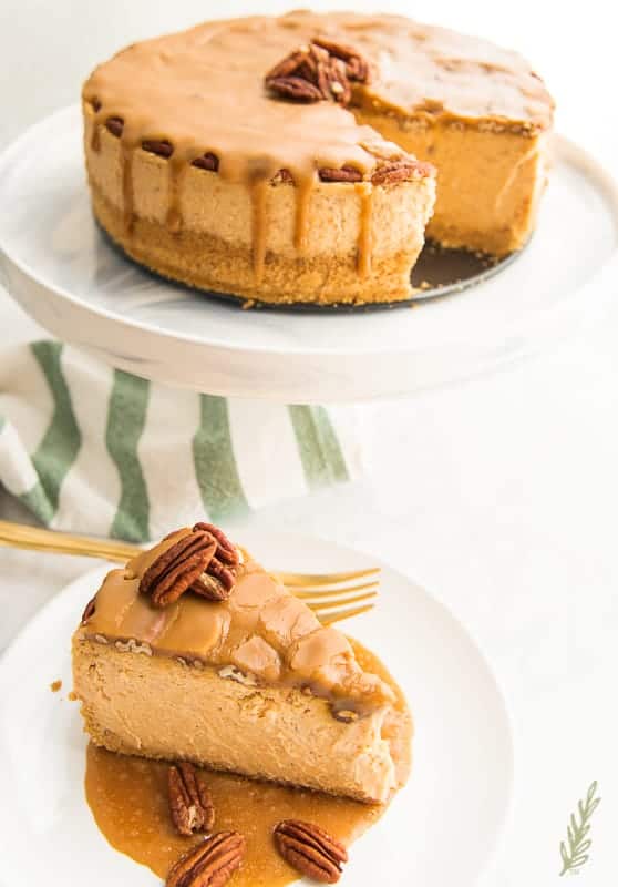 A 3/4 view of the Sweet Potato Cheesecake with Pecan Praline Topping with a slice removed and plated