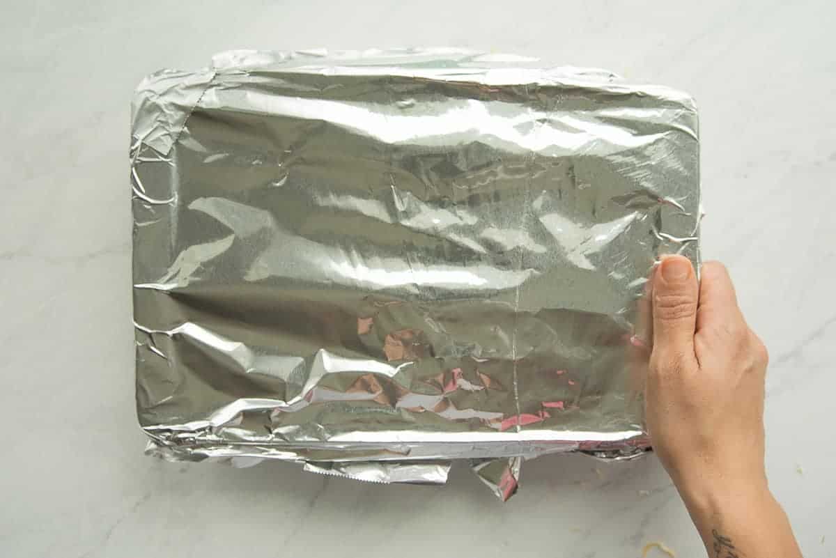 The baking dish covered in aluminum foil.