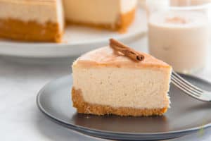 A slice of Creamy Coquito Cheesecake ready to enjoy