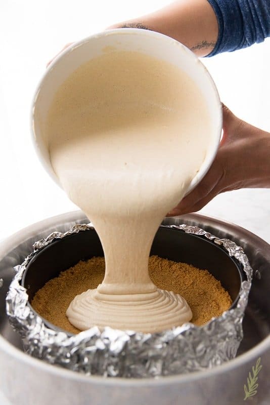 Fill the graham cracker shell with the Creamy Coquito Cheesecake batter