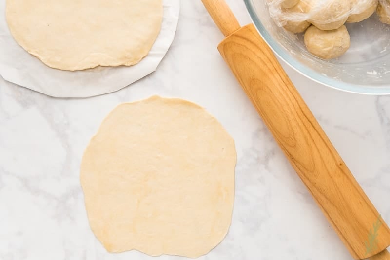 Roll the empanada dough to an 8" circle