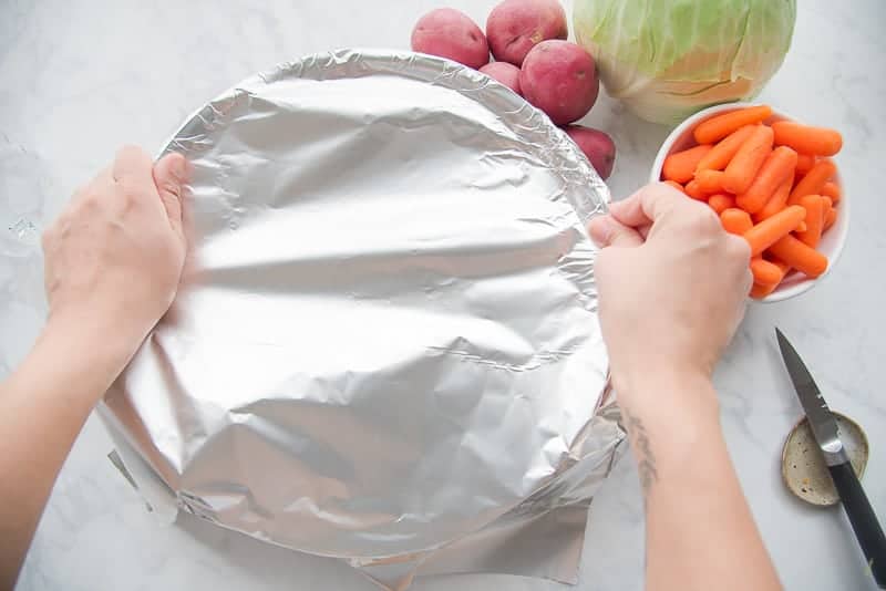 Tightly wrap the pan with heavy duty aluminum foil for the Baked Corned Beef and Cabbage