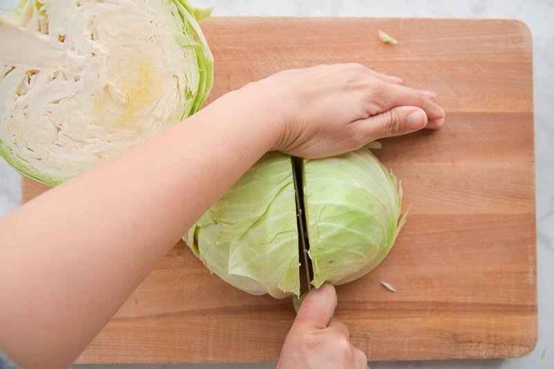Cutting the cabbage into eighths to add to the Baked Corned Beef and Cabbage Dinner
