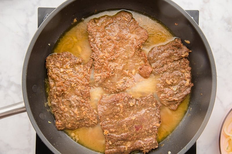the cube steak is sauteed in the onion-flavored oil