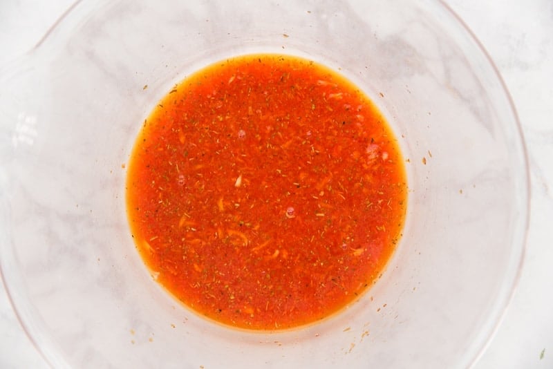 The finished vinegar marinade is in a clear mixing bowl