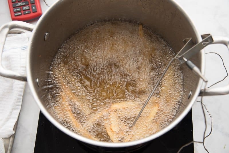 Deep frying the chips in a large pot filled with oil