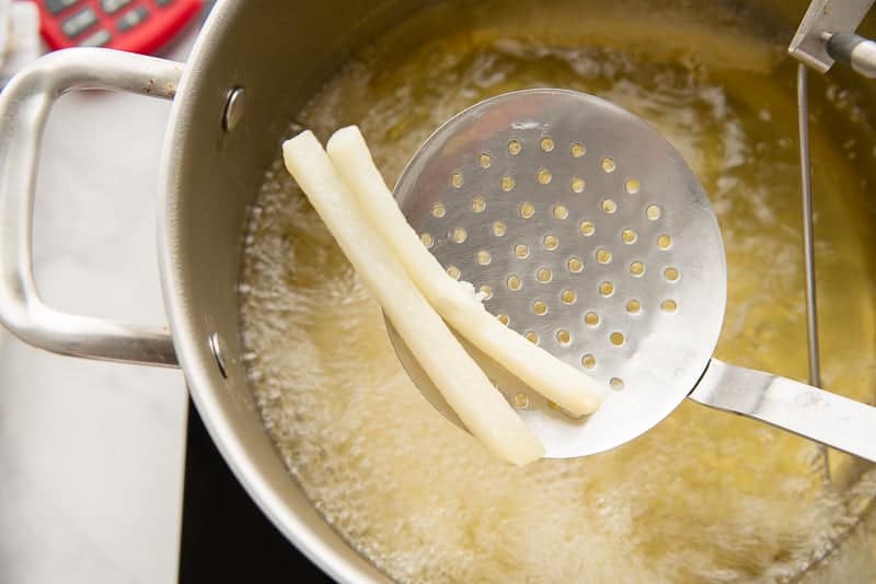 Remove the par-cooked chips from the oil with a spider