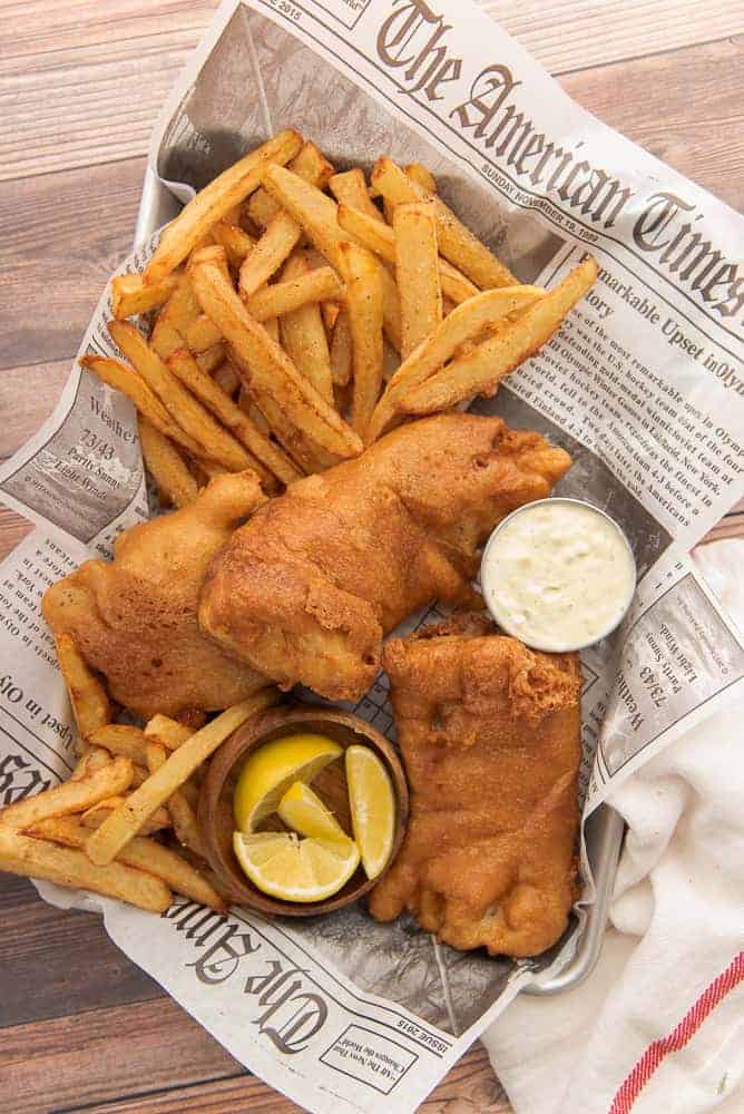 Fish and chips on a newspaper lined tray.