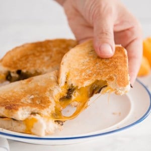 An epic cheese pull from the Grilled Cheese and Chocolate Sandwich
