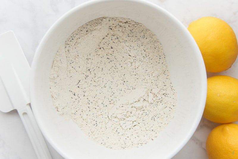 The dry ingredients are mixed together in a white mixing bowl