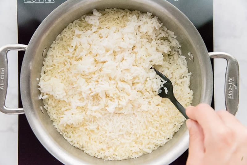 Fluff the steamed white rice with a fork after cooking
