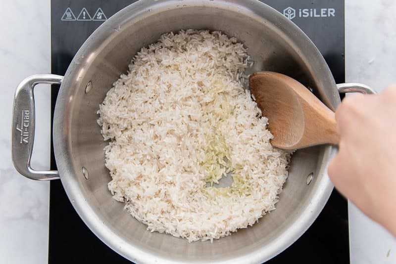 Saute the rice in olive oil to give it a coating of oil