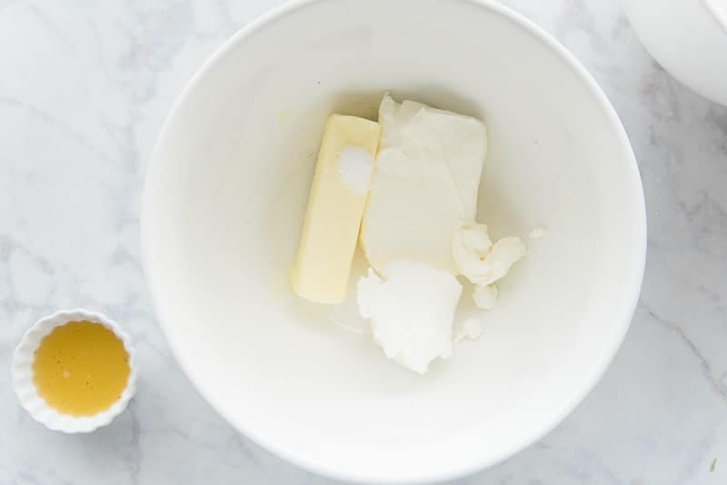 Cream cheese, butter, and shortening are in a white bowl.