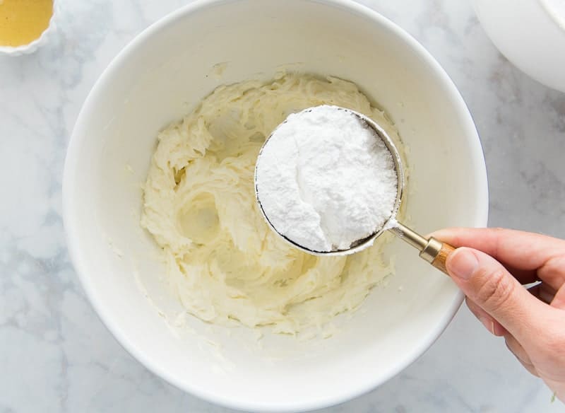 Adding the powdered sugar to the mixing bowl