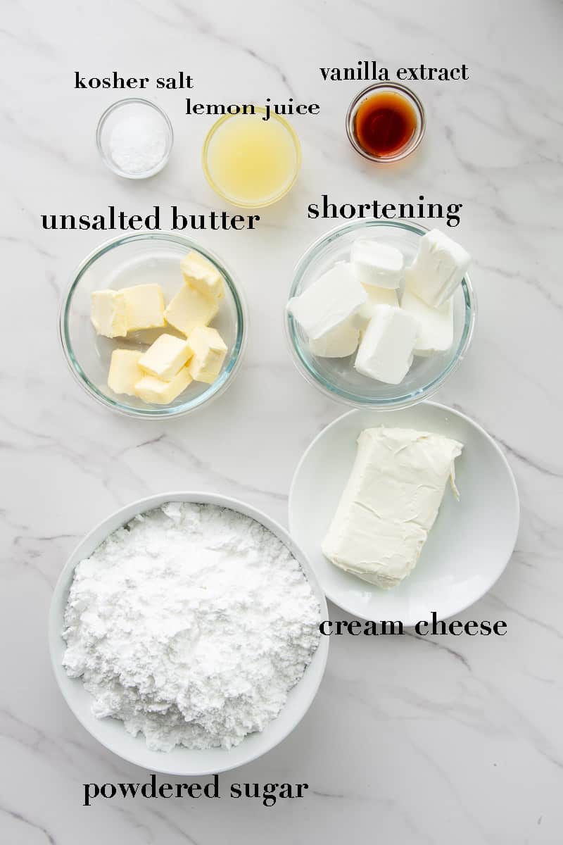 The ingredients needed for Cream Cheese Frosting on a marble countertop.