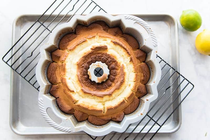 The baked cake is cooled in the bundt pan on a wire rack