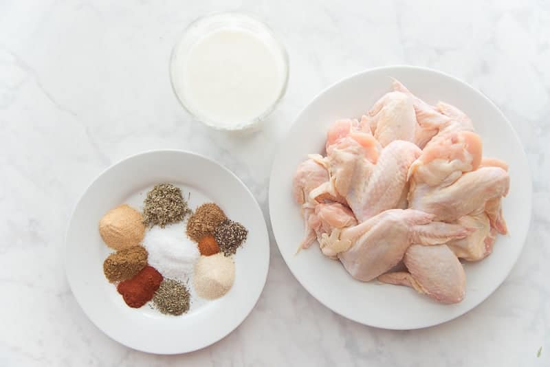 The ingredients need to make the Chicken: buttermilk, chicken pieces, and a spice rub.