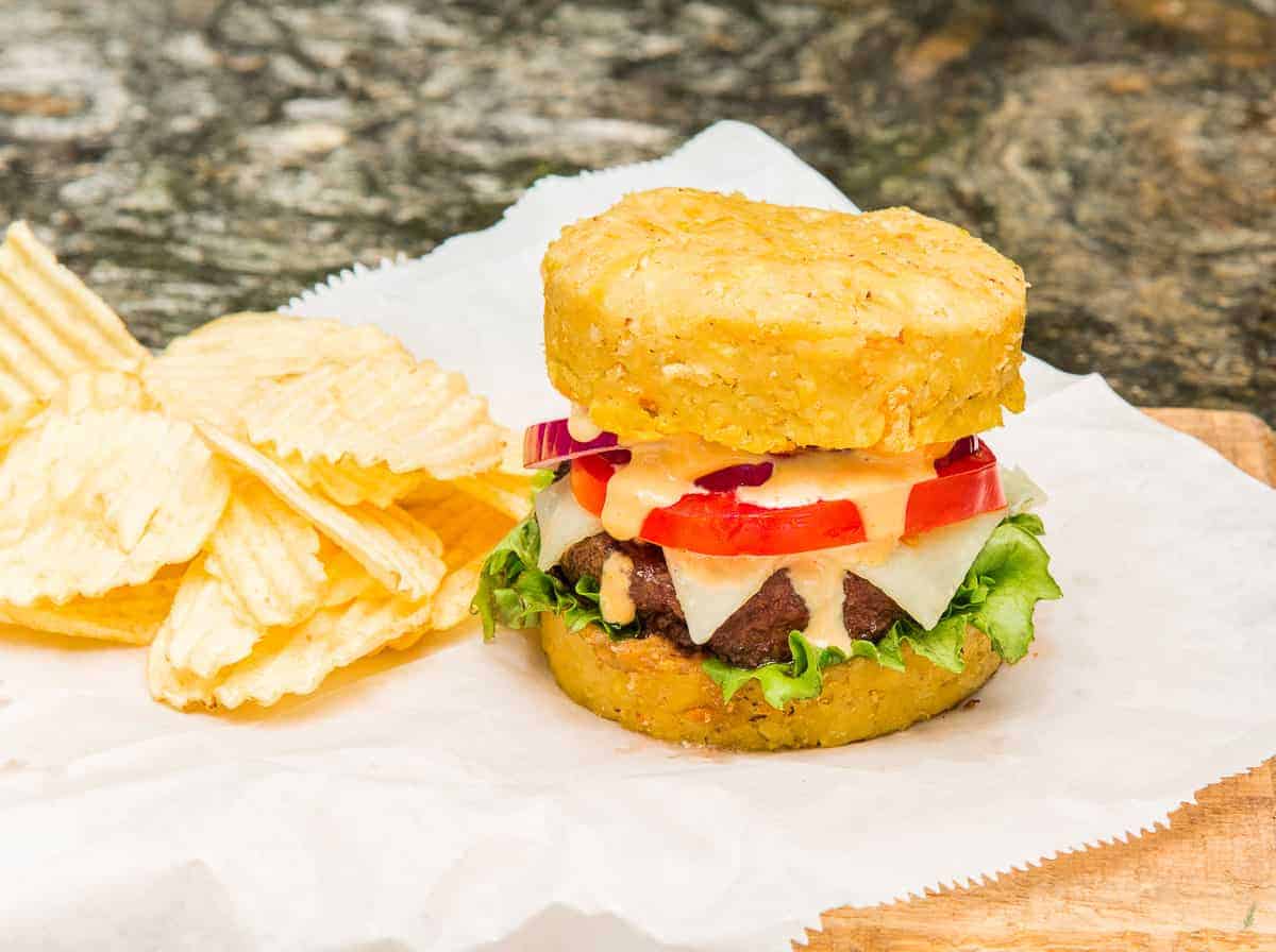 A Mofongo Burger topped with lettuce, tomato, onions, cheese and burger sauce