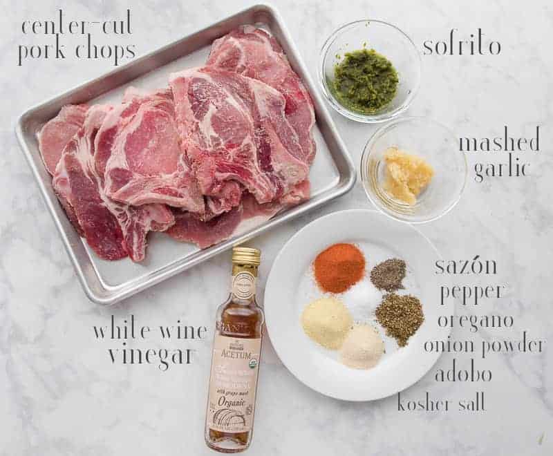 The ingredients list to make the pork chops on a white countertop.