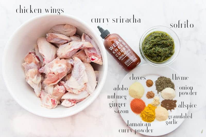 The ingredients for Curry Sriracha Air Fryer Wings: wings, hot sauce, sofrito, and spices.