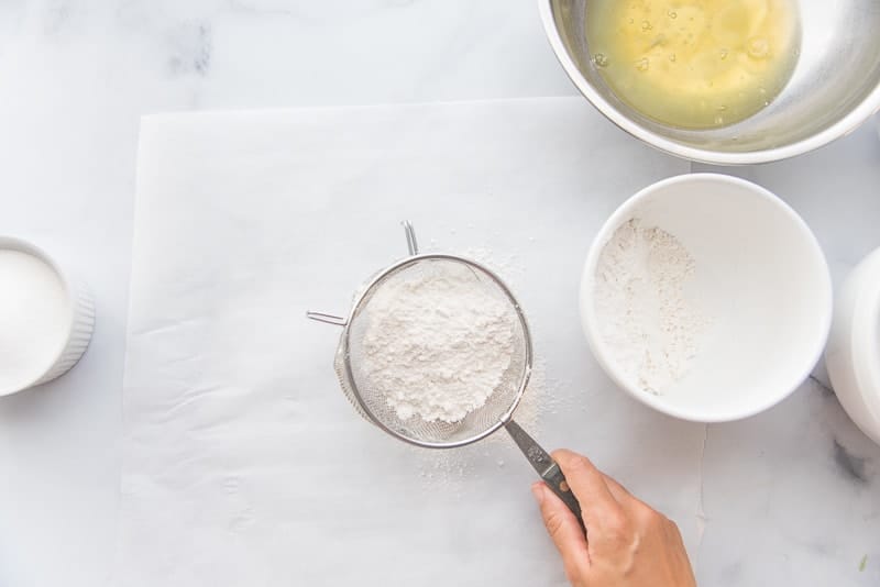 Cake flour is sifted with a metal sifter
