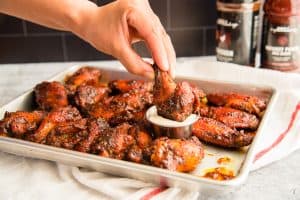 A preview of the Guava BBQ Air Fryer Wings shows a hand dipping a drumette into white dressing.