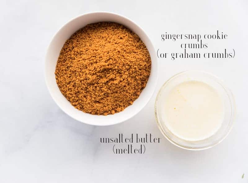 The ingredients needed to make gingersnap crust: gingersnap crumbs and unsalted butter on a marble surface