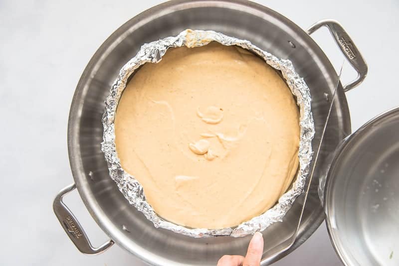 The cheesecake sits in a water bath before being baked