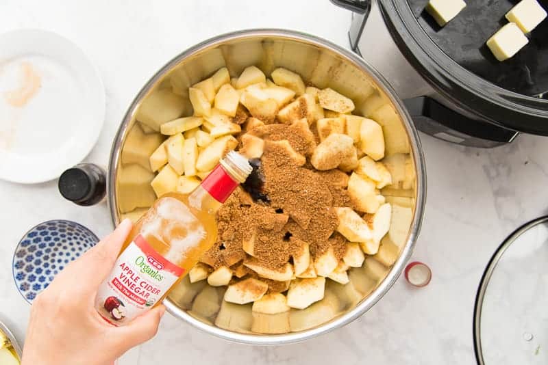 Apple cider vinegar, brown sugar, and spices are added before being cooked