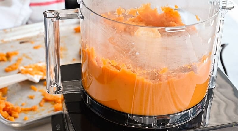 The sweet potatoes are pureed in a food processor