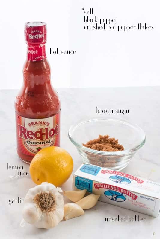 Ingredients for buffalo wing sauce shown: hot sauce, brown sugar, butter, garlic, lemon juice. Black text overlay of unshown ingredients: salt, black pepper, crushed red pepper flakes